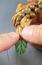 Clay leaf being attached to molded clay